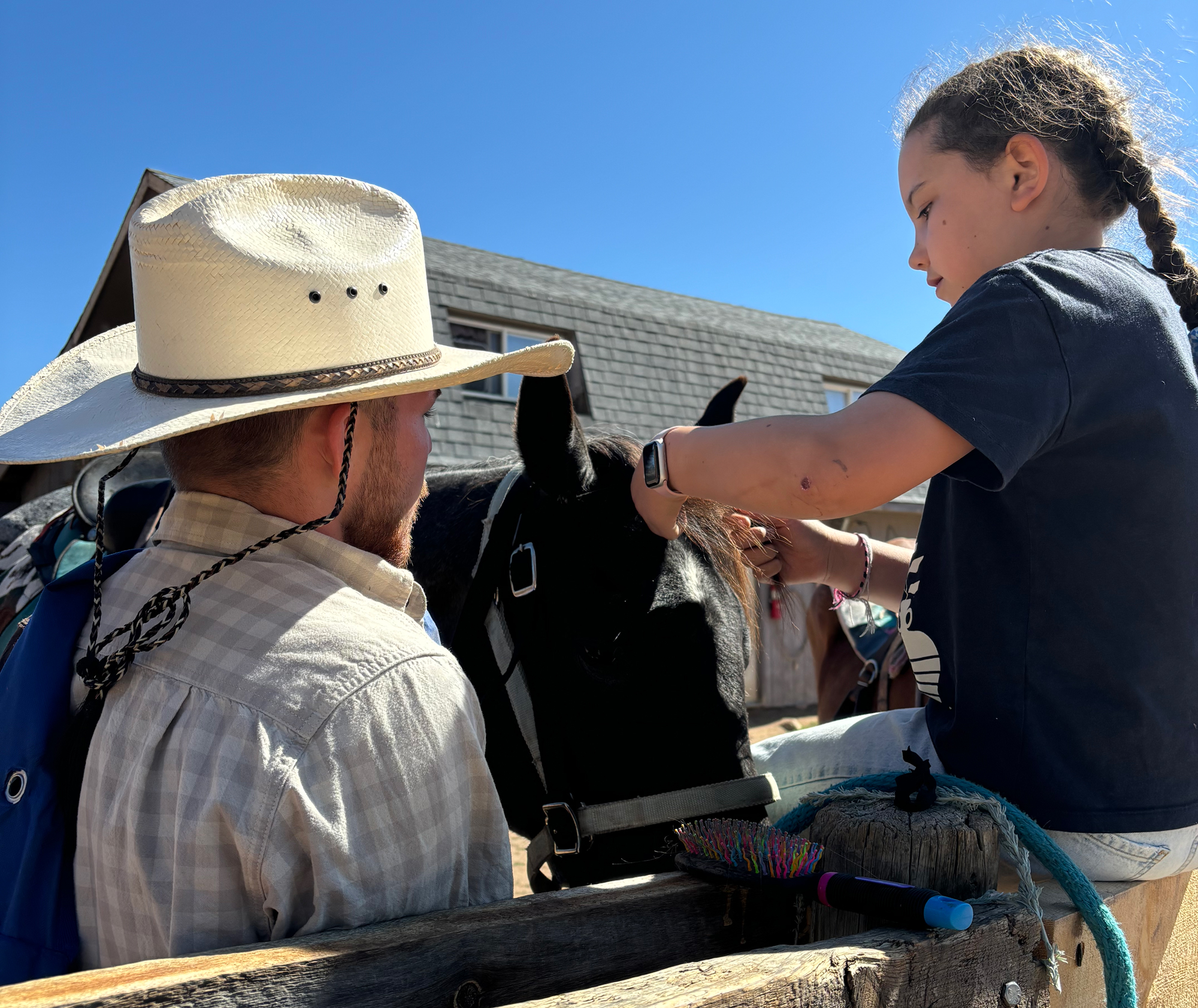 Kid's wrangler with a youngster and her horse for vacations with grandkids