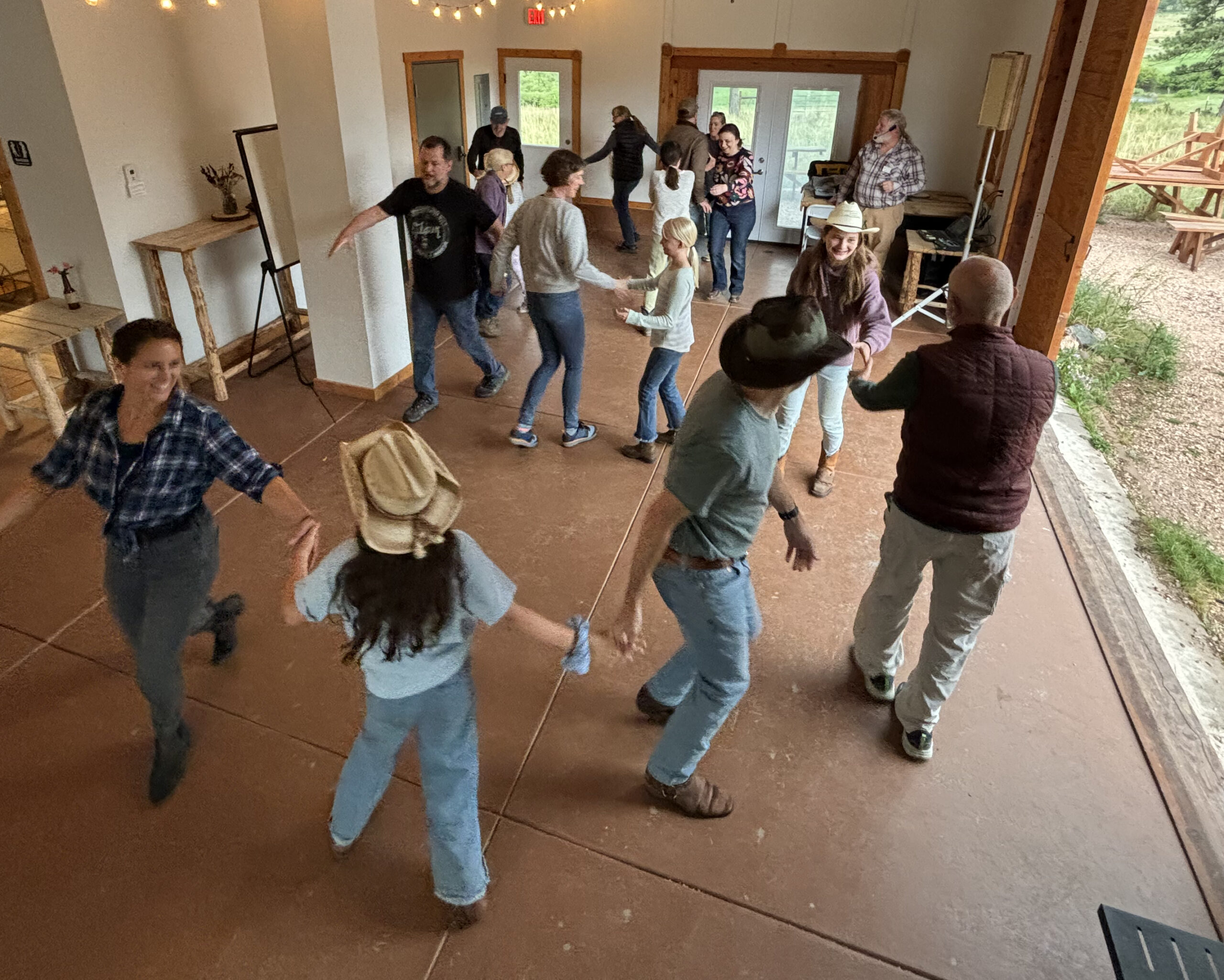 Guests enjoy square dancing at Sundance Trail Guest Ranch, embracing a lively and fun western tradition during their Colorado dude ranch vacation.