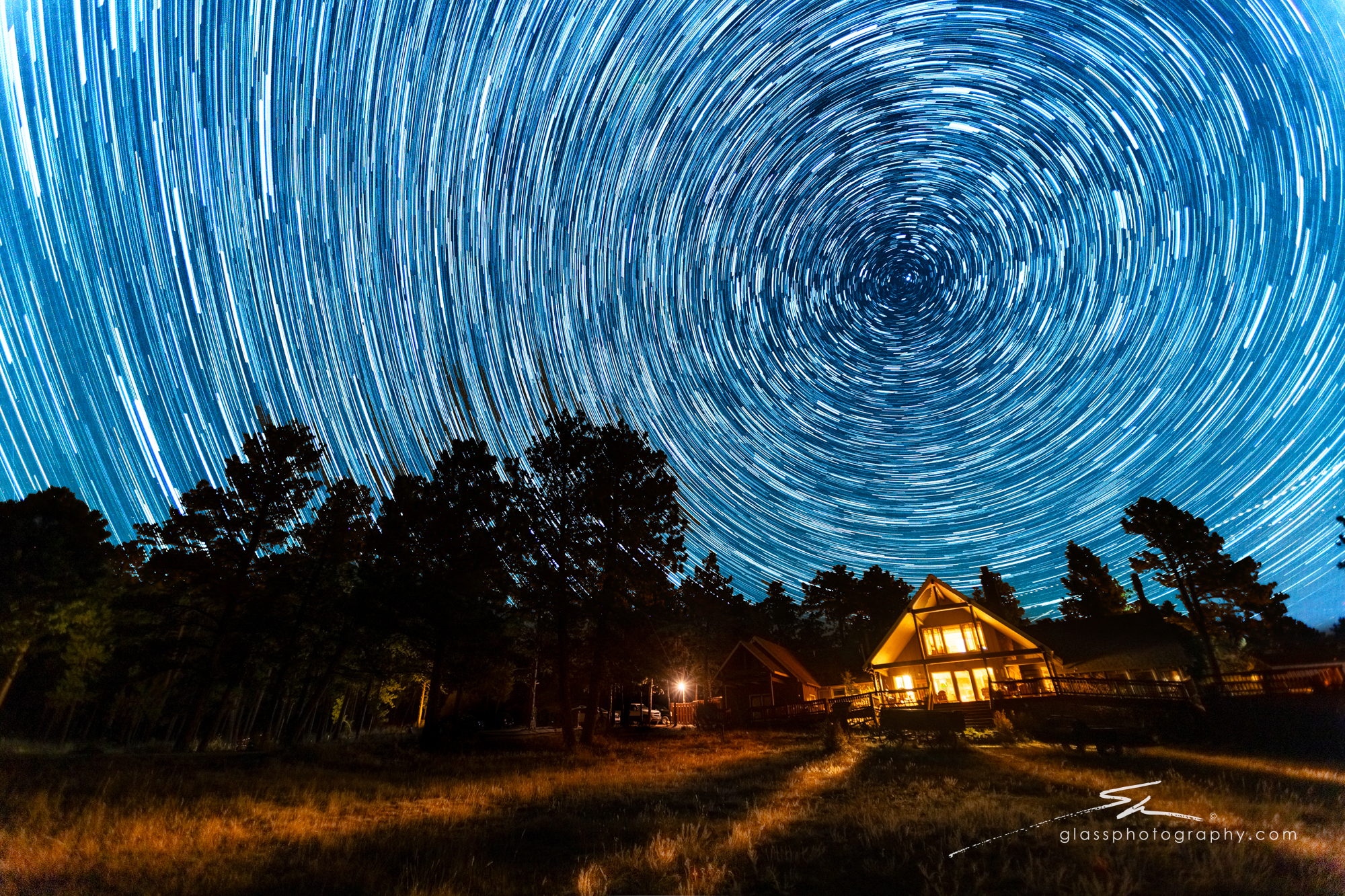 Star trails swirl above the main lodge at Sundance Trail Guest Ranch, capturing the beauty of the Colorado night sky.