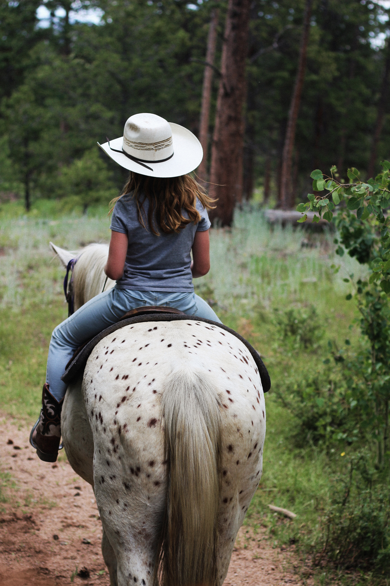 Young girl enjoying her trail ride with Bailey her horse